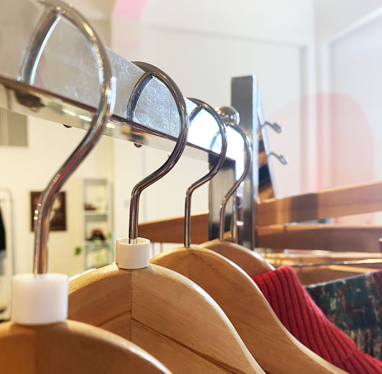 Wooden hanger on clothing rack at Psychic Sister Portland location.