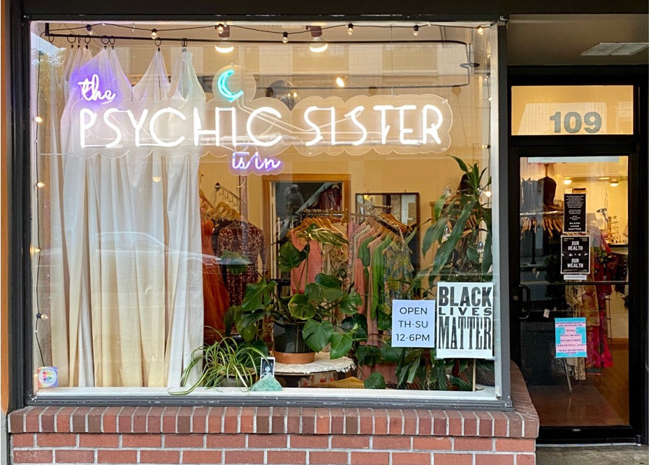 Exterior front shop window of the Psychic Sister Olympia location.