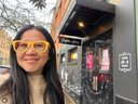 Astrologer theresa tran woman with dark hair and glasses standing in front of Psychic Sister in Portland Oregon