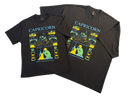 Two black short-sleeve graphic T-shirts laid flat on a white background, featuring a colorful Capricorn-themed print with the word 'CAPRICORN' and astrological imagery.