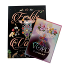 Two boxed art books titled 'The Fertile Voids' shown on a plain white background, one standing upright and one angled in front. The cover art is dark and ornate with pink lettering and fantasy-style illustrations, while the front box has a pastel iridescent cover with flowers and the text '12 art and 12 book.