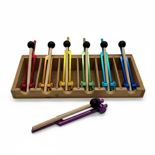 Set of colorful mallets in a wooden holder on a white background
