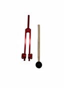 Red tuning fork and wooden mallet on a white background