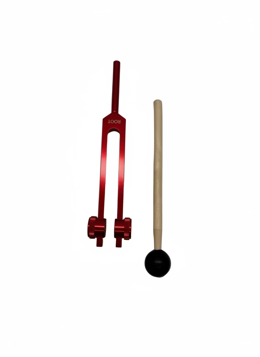 Red tuning fork and wooden mallet on a white background