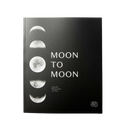 A black hardcover journal titled 'MOON TO MOON' with a vertical row of moon phase photographs on the left side and white text, photographed against a plain white background.