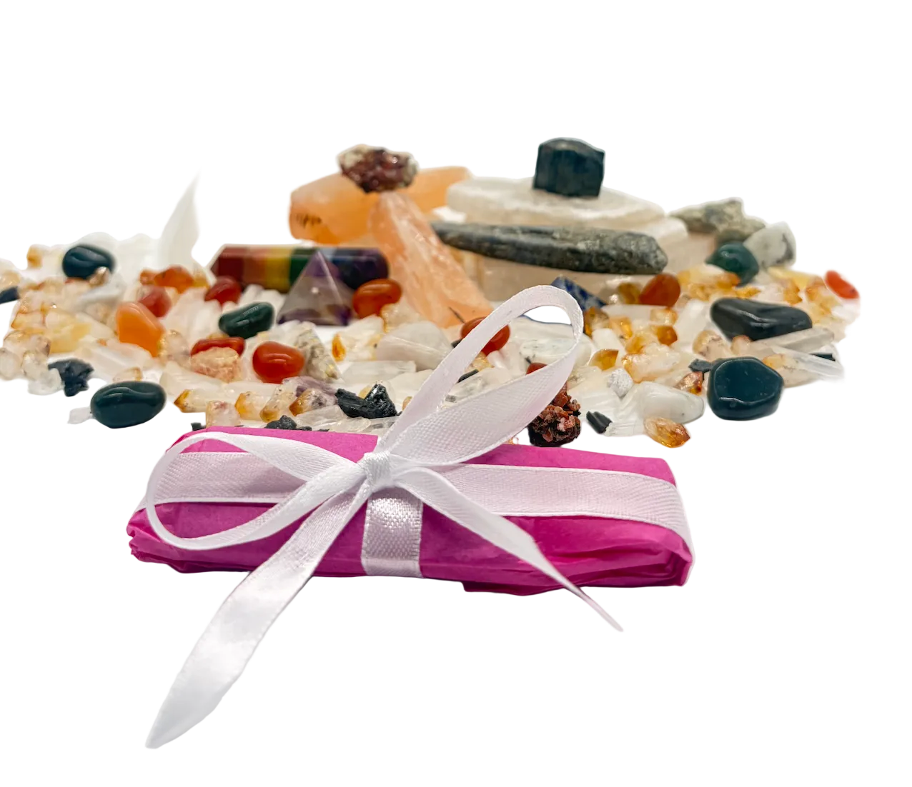 Pink package with a white ribbon surrounded by colorful stones on a white background
