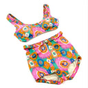 Flat lay of vintage bikini in pink 60's print.