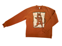 A brown crewneck sweatshirt featuring a graphic print of a woman with pink hiar curled up in the fetal position taking a nap on the underbelly of a  cartoon cat lounging on a pillow embroidered with the words Psychic Sister