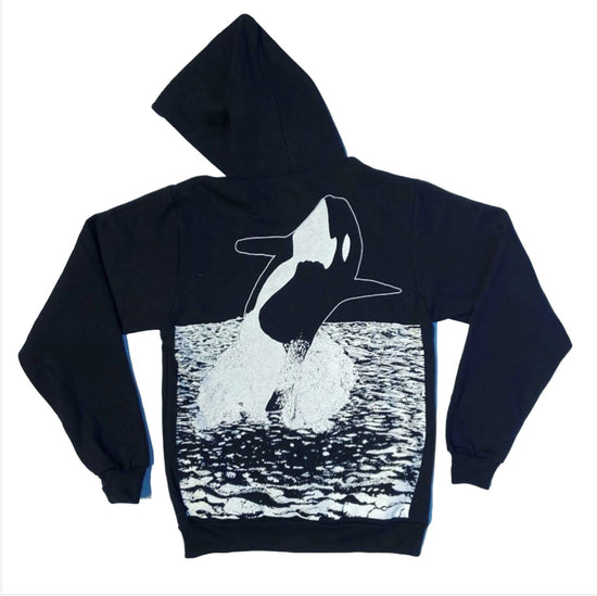 Back of black long sleeve hoodie sweater with Orca breaching artwork.