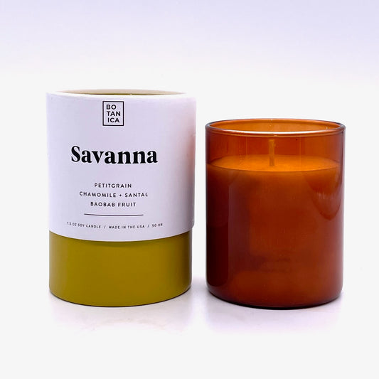 Amber Glass Candle next to White & Chartreuse Tube Package with Black Text