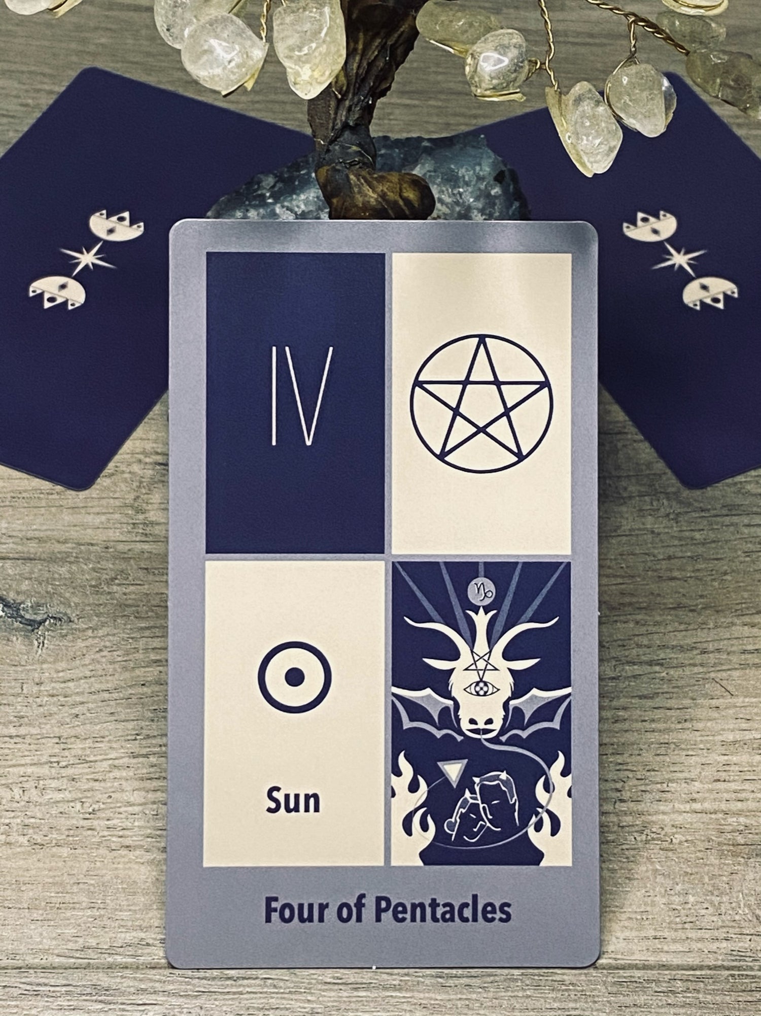 Four of pentacles from the Astro Crown tarot deck.