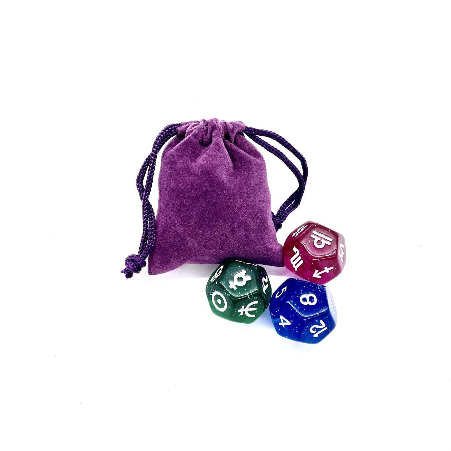 Three astro dice next to a purple velvet pouch.