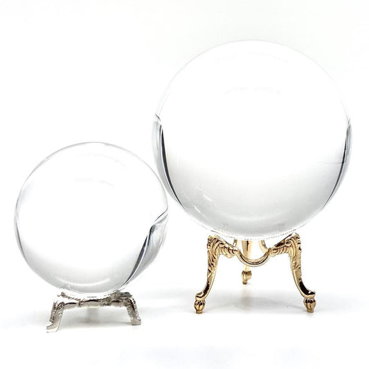 Large and small gazing balls on silver and gold stands.