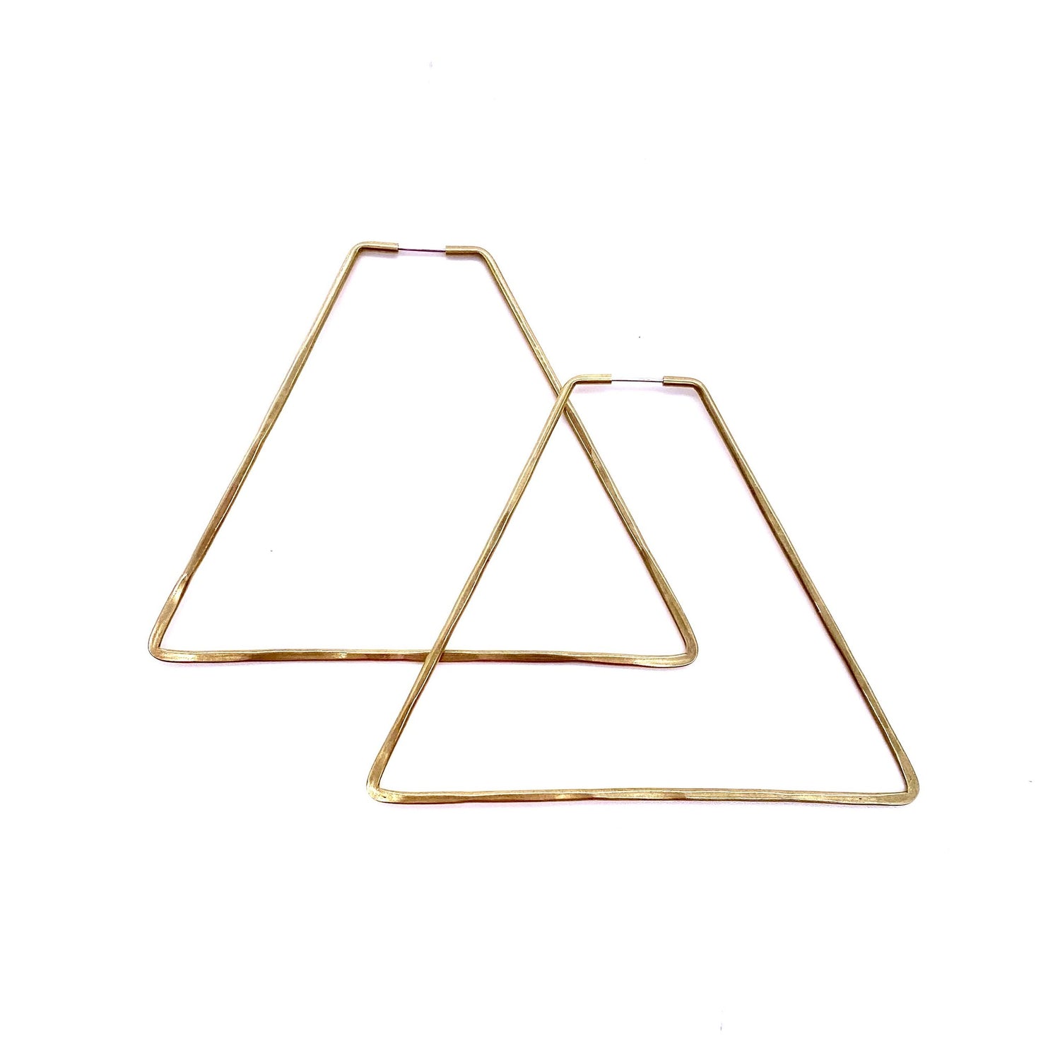 Brass geometric hoop earrings in pyramid shape.