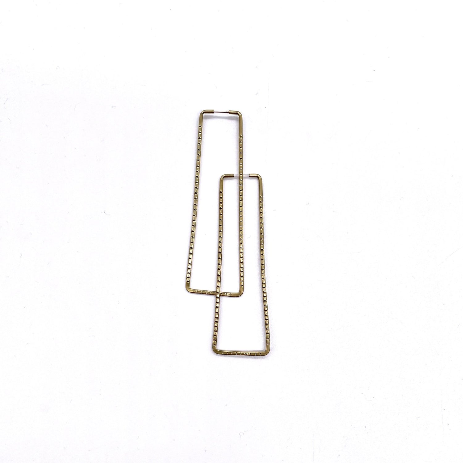 Brass geometric hoop earrings in ridged rectangle shape.