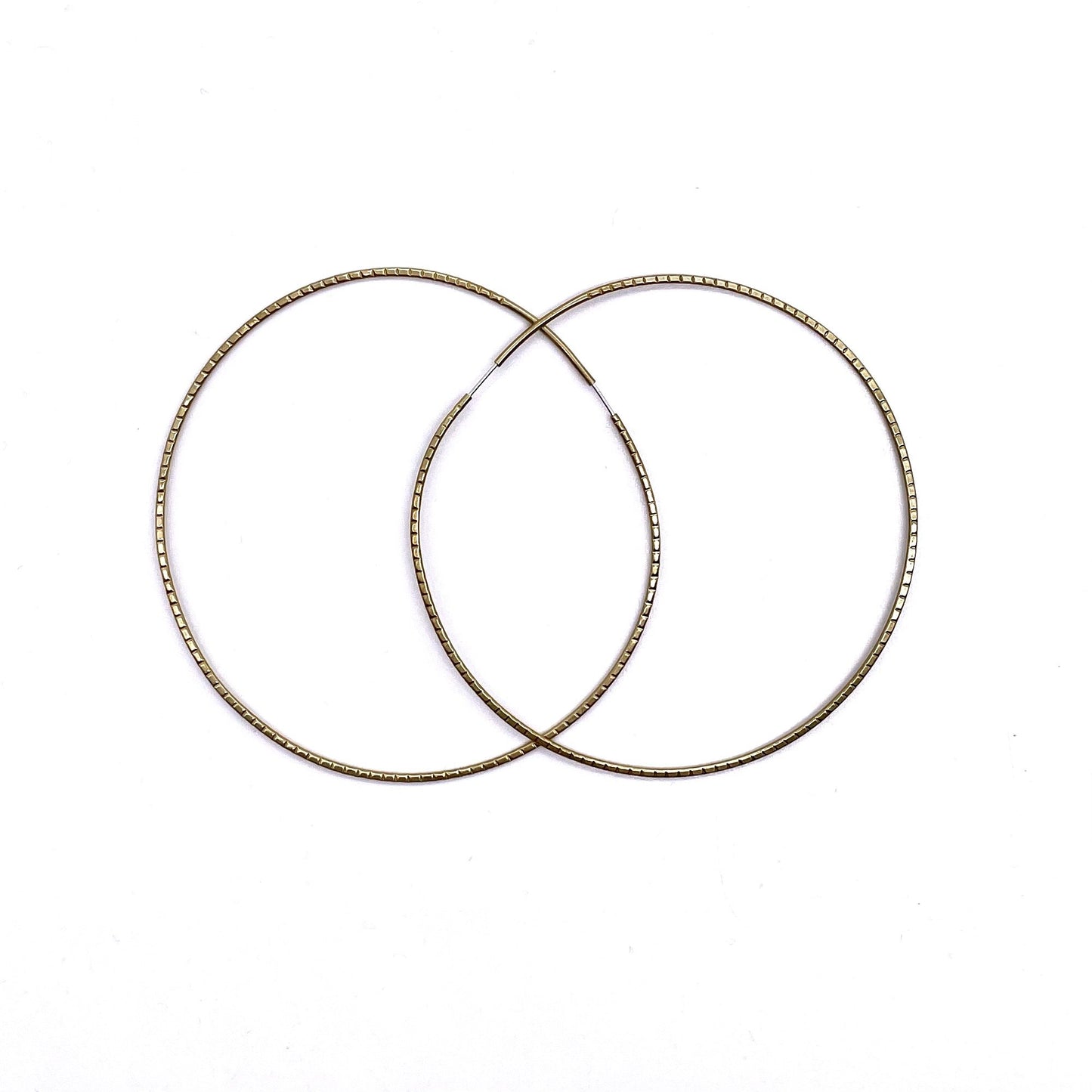 Brass geometric hoop earrings in redged solar 4-inch shape.