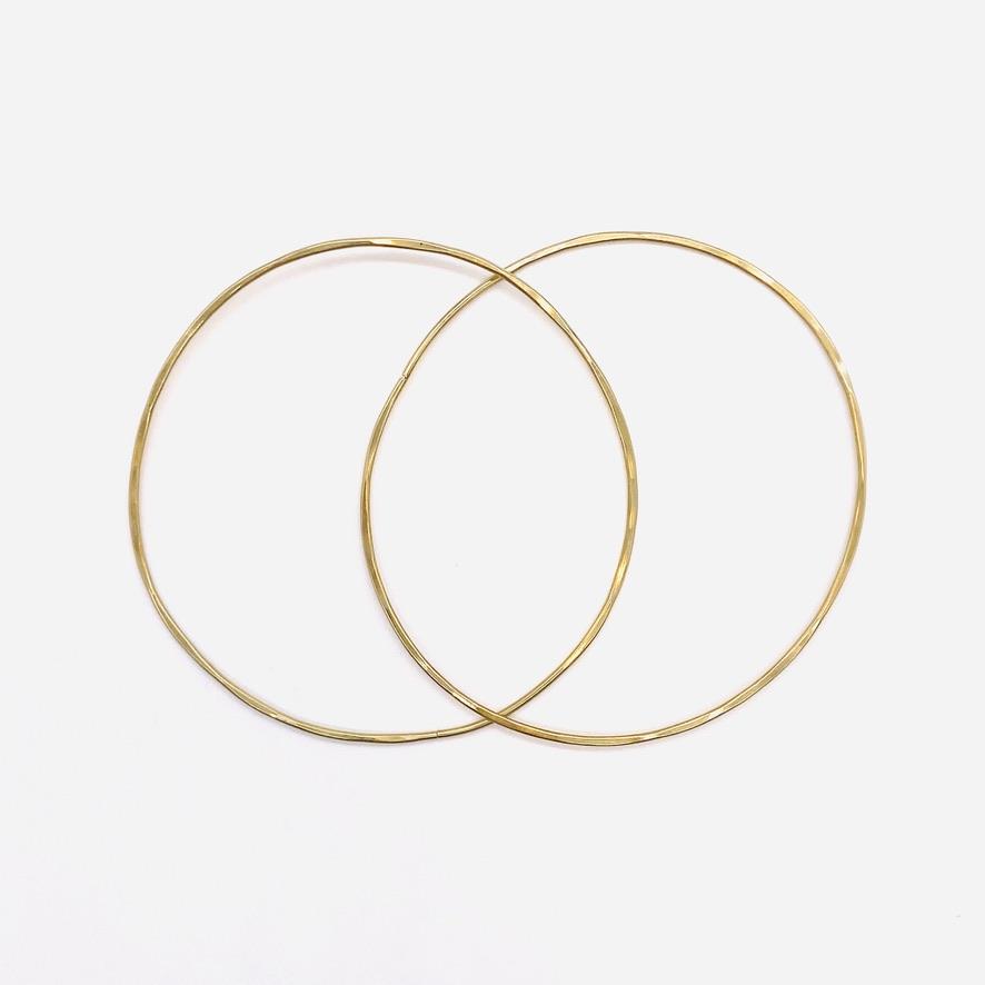 Brass geometric hoop earrings in solar 2-inch shape.