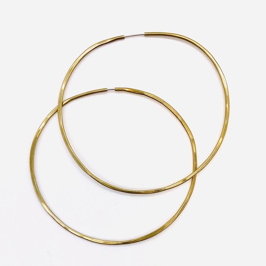 Brass geometric hoop earrings in solar 4-inch shape.