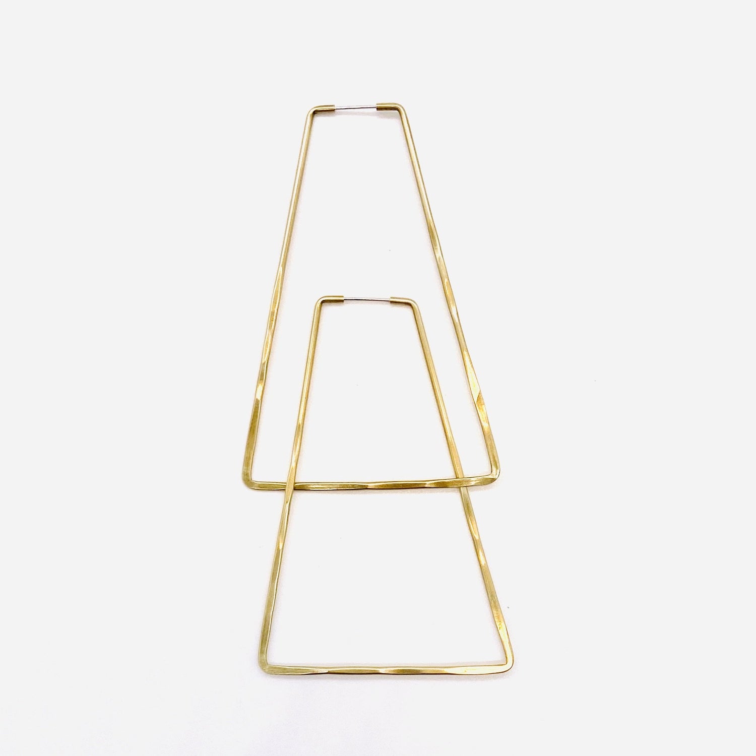 Brass geometric hoop earrings in triangle shape.
