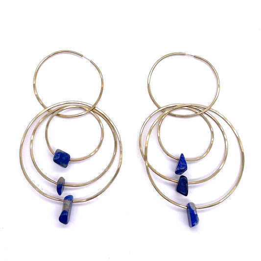  Brass Earrings with Hoops of varying sizes, chained together, each hoop has a piece of lapis lazuli hanging from it. 