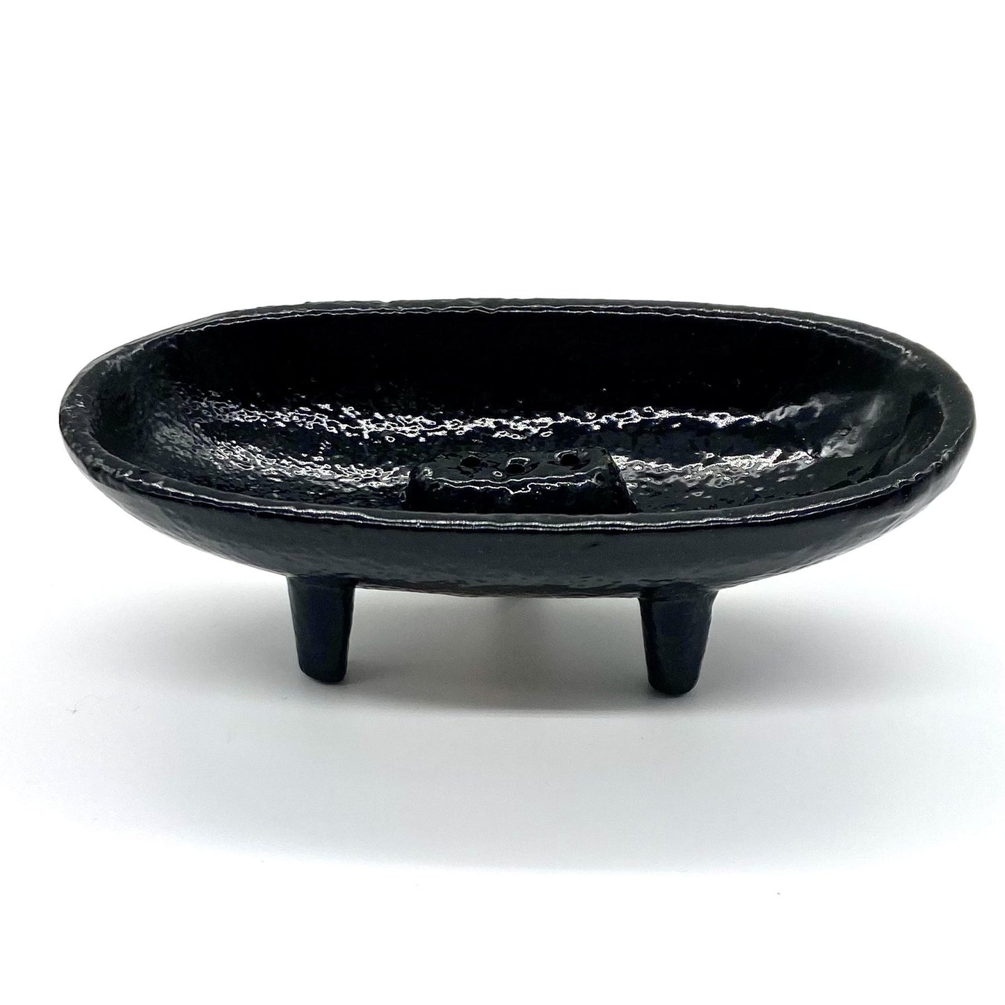 Cast iron incense burner in boat shape with legs.