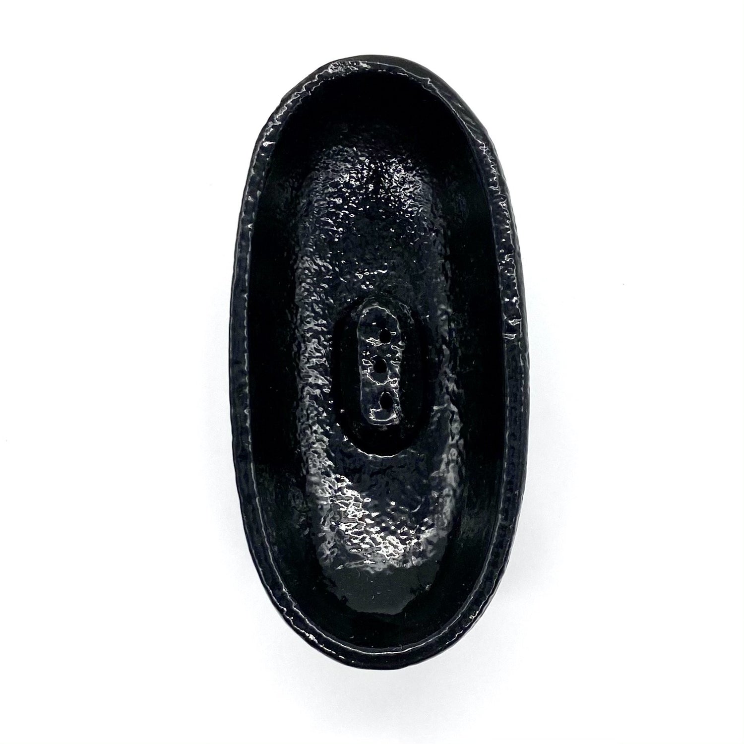 Cast iron incense burner in boat shape with legs.