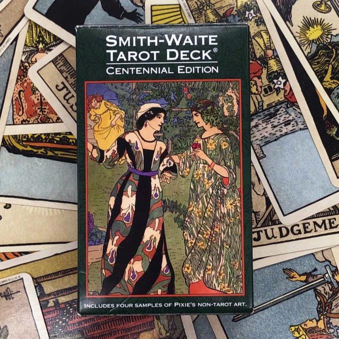 Box cover art of the Smith Waite Centennial Tarot deck with collection of cards.