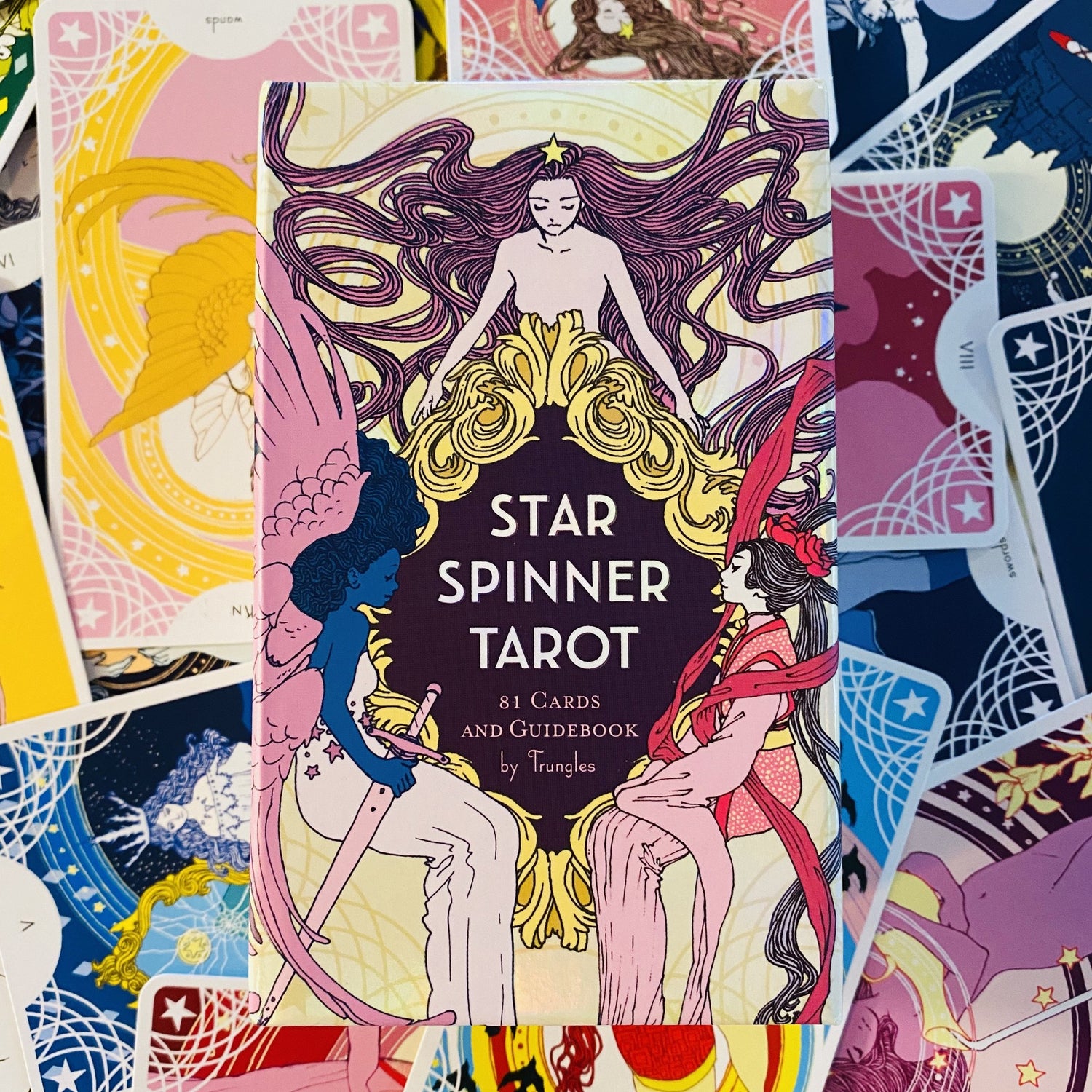 Box cover art of the Star Spinner Tarot with collection of cards.