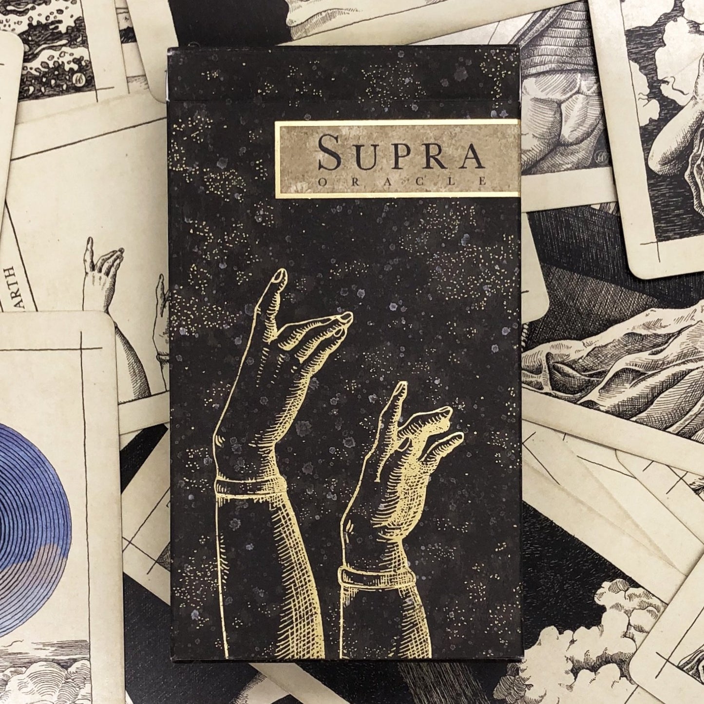 Box cover art of the Supra Oracle deck with collection of cards.